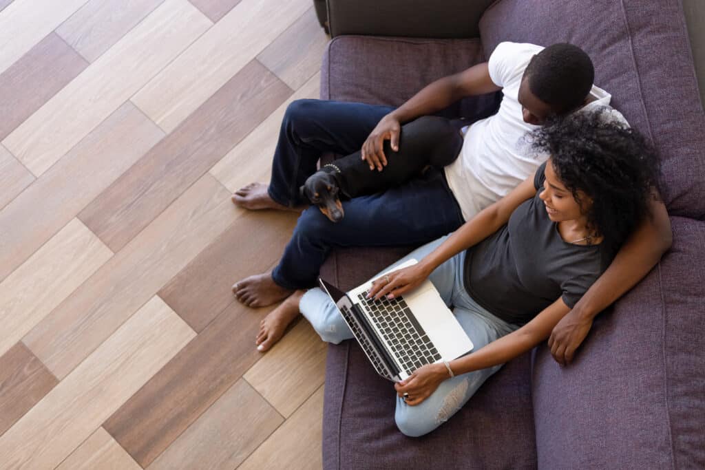 Couple getting financing on a computer from TPC Roofing